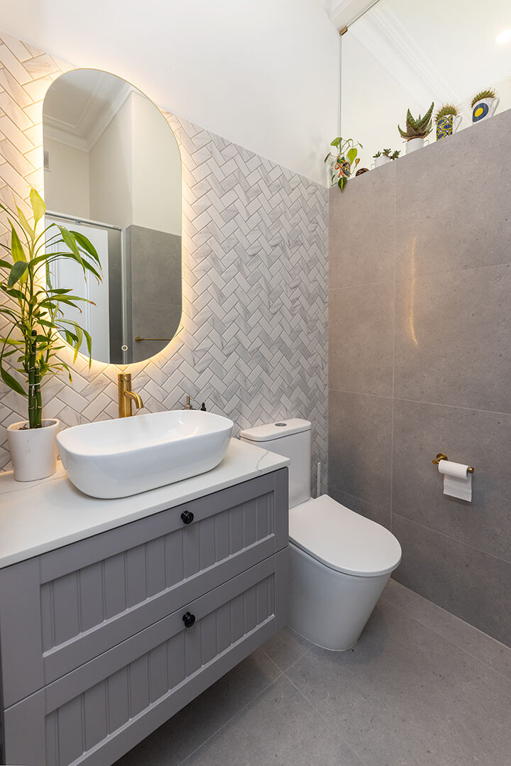 Completed ensuite renovation with tiled walls and vanity